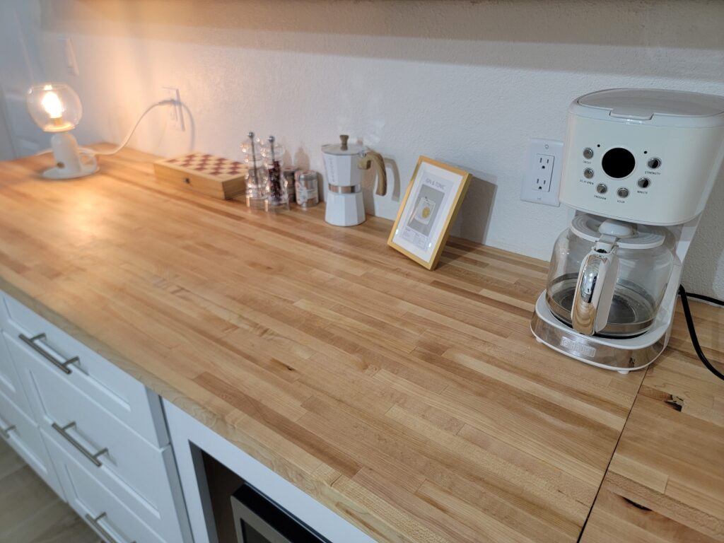 Coffee machines, drip and espresso, on wooden counter, with chess board, salt and pepper set and other memories from Four Turtles Villas on Hoopers Bay