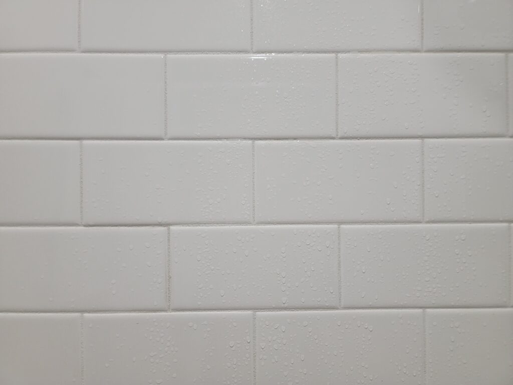 Rectangular white shower tiles in all four en-suite bathrooms