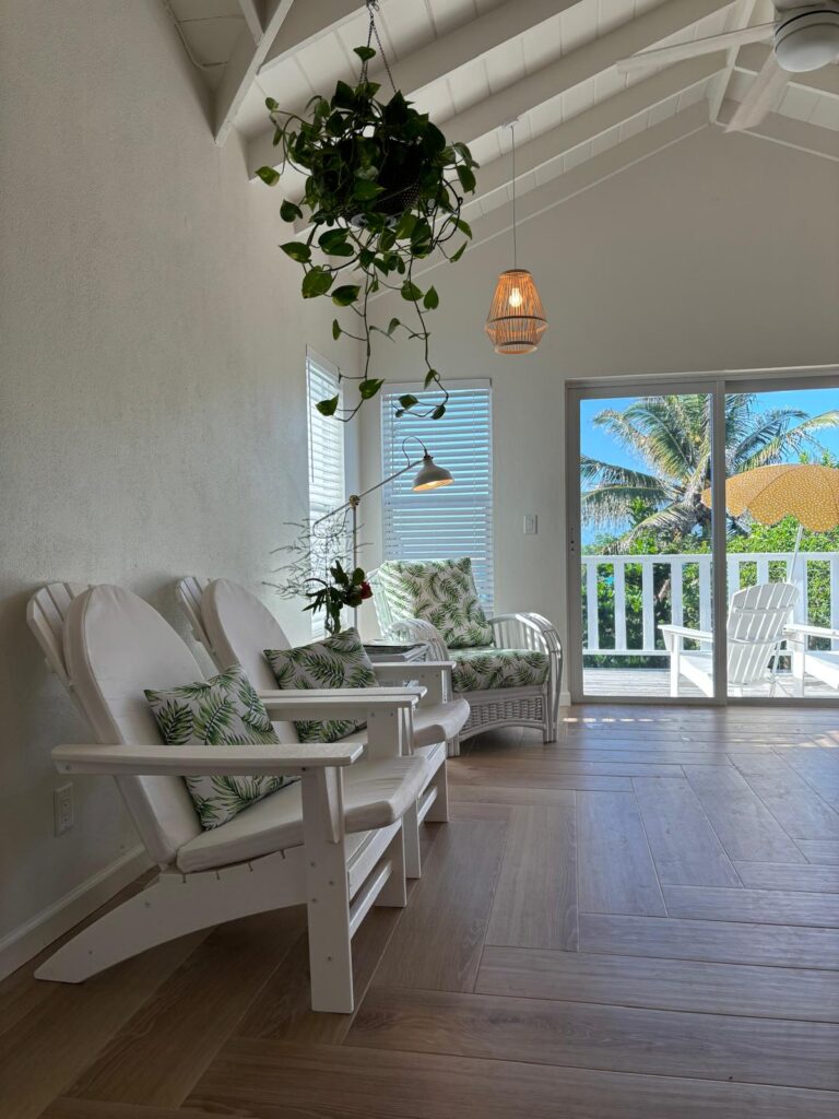 Living room of Sunrise Turtle rental beach cabana with view of patio and umbrella