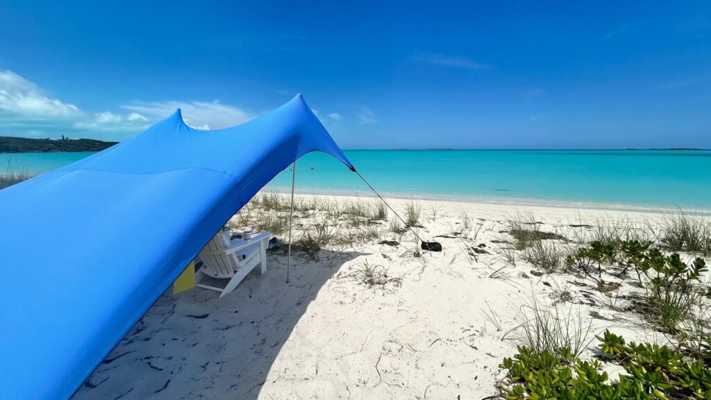 White sand beach and Hoopers Bay's turquoise water in front of Four Turtles Rental Beach Villas 