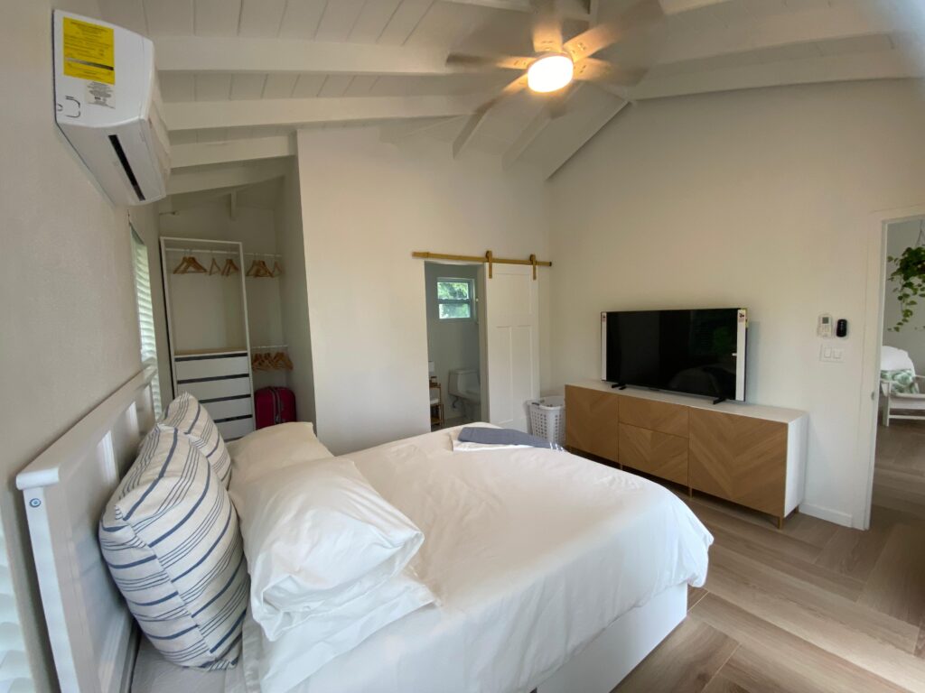 Queen bed an smart TV in master bedroom of Sunrise Turtle rental beach villa at Four Turtles Villas