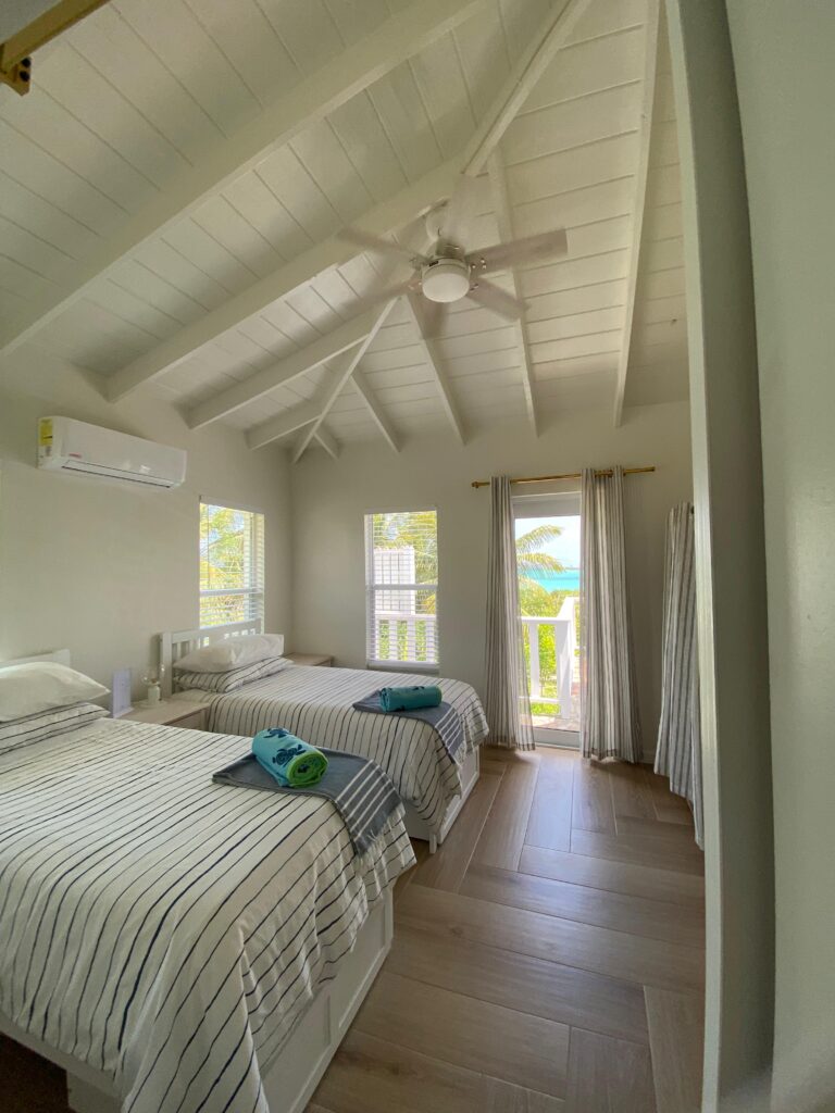 Twin beds from kids bedroom of Sunrise Turtle rental beach villa at Four Turtles Villas