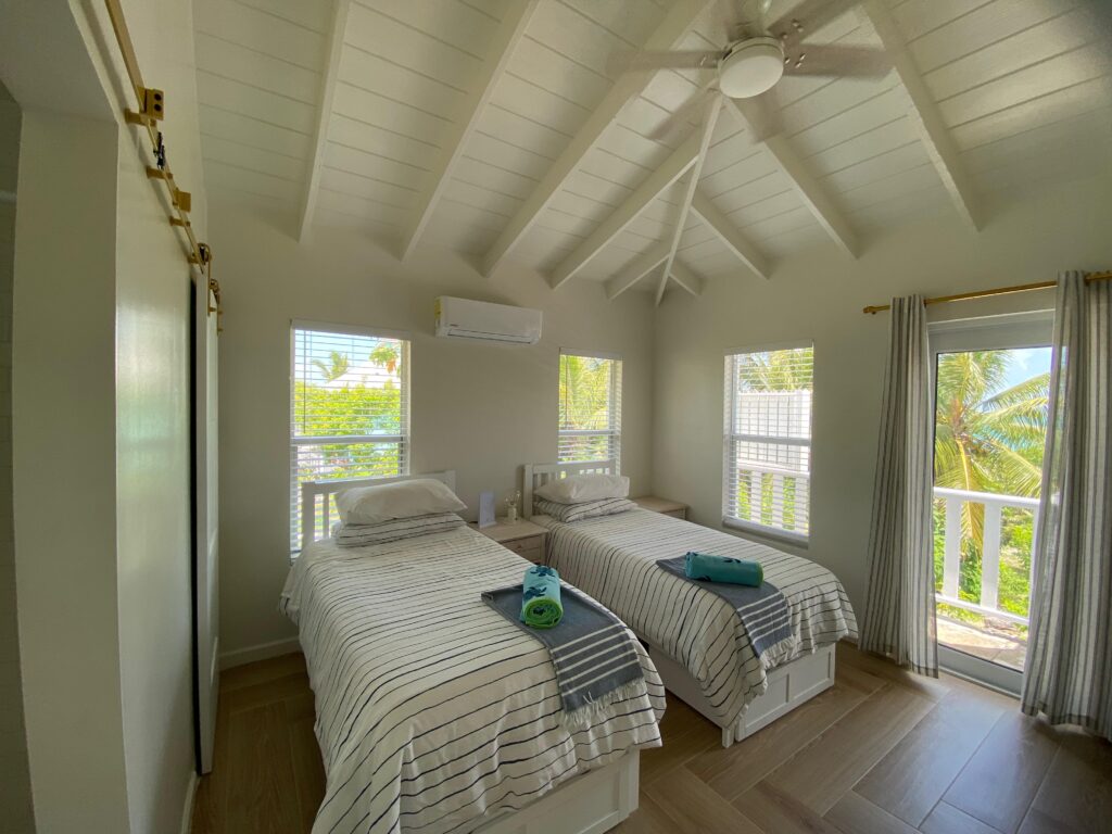 Twin beds from kids bedroom of Sunrise Turtle rental beach villa at Four Turtles Villas